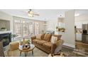 Bright, open living room with a comfortable sofa, fireplace, and natural light, perfect for relaxing at 5622 Dartington Dr, Indian Land, SC 29707
