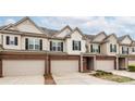 Attractive townhome featuring neutral siding, black shutters, and a well-kept lawn with mature landscaping at 5951 Carrollton Ln, Charlotte, NC 28210