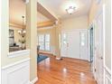 Welcoming foyer with hardwood floors and elegant wainscoting at 6144 Abergele Ln, Matthews, NC 28104
