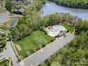 An aerial view of a community pool and recreation area surrounded by lush greenery and ample parking at 6529 Jepson Ct, Charlotte, NC 28214