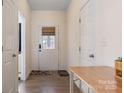 Bright entryway featuring hardwood floors, a decorative front door, and neutral paint at 6816 Pennyroyal Way, Charlotte, NC 28216