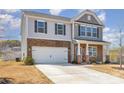 Charming exterior view of the two-story home showcasing the stone and siding facade and driveway at 715 Saddlebred Ln, Locust, NC 28097