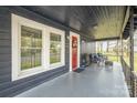 Inviting front porch with dark wood and sitting area at 1013 East Dr, Gastonia, NC 28052