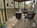 Relaxing porch area featuring comfortable seating, a fire pit table, and a tranquil view of the outdoors at 104 Little River Trl, Fort Mill, SC 29707