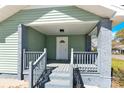 View of covered porch with gray wood railings and pillars at 109 Broad St, Shelby, NC 28152