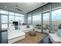 Bright living room with floor-to-ceiling windows and a comfortable white sofa at 1100 Metropolitan Ave # 314, Charlotte, NC 28204