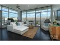 Bright living room featuring floor to ceiling windows, hardwood floors, and a comfortable white sofa at 1100 Metropolitan Ave # 314, Charlotte, NC 28204