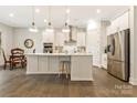 Open kitchen with stainless appliances, white cabinets, island with stool seating, and breakfast nook at 11019 Kilkenny Dr # 41, Charlotte, NC 28277