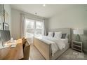 Comfortable bedroom featuring a large window, neutral tones, and a desk setup at 11036 Shreveport Dr, Huntersville, NC 28078