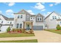 Charming two-story home with a well-manicured lawn, gray siding, and a two-car garage at 11036 Shreveport Dr, Huntersville, NC 28078