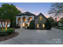 Elegant home featuring a stone facade, dramatic entrance, and manicured landscaping at 114 Ventana Ct, Mooresville, NC 28117