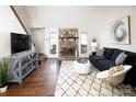 Bright living room with stone fireplace, vaulted ceiling, and modern decor at 11901 Rock Canyon Dr, Charlotte, NC 28226