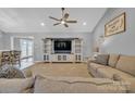 Comfortable living room with a ceiling fan, neutral carpet, a large TV, and a cozy couch at 1584 Beverly Ln, Lincolnton, NC 28092