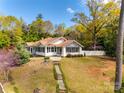 Charming craftsman-style home with a stone walkway, mature landscaping, and inviting curb appeal at 165 Mimosa Ter, Wadesboro, NC 28170