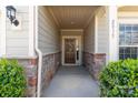 Inviting entryway with stone accents, house number, and a charming front door with decorative wreath at 2035 Palace Way, Indian Land, SC 29707