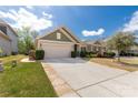 Well-maintained home featuring lush lawn, two-car garage, stone accents, and a beautifully landscaped yard at 2035 Palace Way, Indian Land, SC 29707
