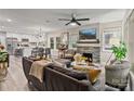 Open-concept living room with a stone fireplace and modern decor, flowing into the kitchen at 2117 Camp Greene St, Charlotte, NC 28208