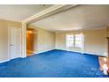 Inviting living room with fireplace, neutral walls, white trim and large window with sheer curtains at 216 Sylvan Rd, China Grove, NC 28023