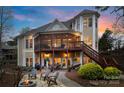 Back exterior with spacious screened porch, deck and an outdoor seating area with fire pit for entertaining guests at 2228 Metcalf Dr, Sherrills Ford, NC 28673