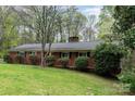 A traditional brick home featuring a cozy facade and complemented by lush green landscaping at 2714 Dogwood Cir, Charlotte, NC 28208