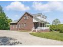 Side view of a brick home with a covered porch and ample parking space at 2805 Sadler Rd, Alexis, NC 28006
