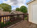 View from balcony overlooking courtyard, featuring wooden railing and door to the building at 3210 Selwyn Farms Ln # 7, Charlotte, NC 28209