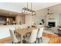 Open concept dining area with modern lighting adjacent to a living room and kitchen area at 3210 Selwyn Farms Ln # 7, Charlotte, NC 28209