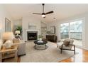 Bright living room features a fireplace, built-in shelving, and sliding doors to an outdoor deck at 3210 Selwyn Farms Ln # 7, Charlotte, NC 28209