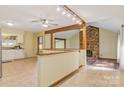 Open-concept living space with brick fireplace, wood floors, and a view into the kitchen at 3846 22Nd Ne St, Hickory, NC 28601