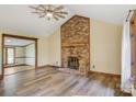 Spacious living room with a brick fireplace, wood floors, and natural light from the windows at 3846 22Nd Ne St, Hickory, NC 28601