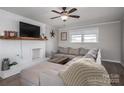 The living room has hardwood floors, a fireplace, a ceiling fan, and a large sectional sofa at 396 Tower Rd, Vale, NC 28168