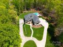 Stunning aerial view showcases circular driveway and lush wooded surroundings at 4071 King Wilkinson Rd, Lincolnton, NC 28092