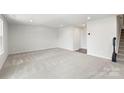Large basement with neutral carpet offers versatile space and potential for customization at 408 Moondance Dr # C, Gastonia, NC 28054