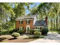 Beautiful brick home surrounded by mature trees, offering a serene and private setting at 4522 Woods End Ln, Charlotte, NC 28277