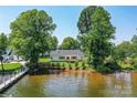 Lakefront property featuring a private beach and dock for easy access to recreational waters at 4980 Kiser Island Rd, Terrell, NC 28682