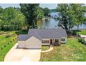 Charming home featuring a three-car garage, well-maintained lawn, and classic architectural details at 4980 Kiser Island Rd, Terrell, NC 28682