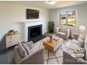 Bright living room with stylish furniture, a decorative fireplace, and large windows for natural light at 614 Normandy Rd, Lancaster, SC 29720