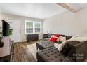 Bright living room featuring luxury floors, comfortable seating, and natural light from the windows at 6354 Old Pineville Rd # F, Charlotte, NC 28217