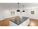 Spacious, open-concept kitchen with island and eat-in dining area featuring hardwood floors at 6614 Old Providence Rd, Charlotte, NC 28226