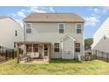 Rear view of a home featuring a covered patio and fenced yard at 7394 Echoing Hills Ln, Maiden, NC 28650