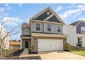 Attractive two-story home with a two-car garage, brick accents, and gray siding at 7394 Echoing Hills Ln, Maiden, NC 28650