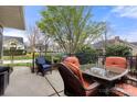 Outdoor patio featuring a dining table, chairs, and a view of the surrounding neighborhood at 744 Ledgestone Ct, Tega Cay, SC 29708