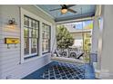 Relaxing porch with a swing, modern light fixture, and a blue rug at 806 Sunnyside Ave, Charlotte, NC 28204