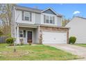 Charming two-story home features a gray siding, stone accents, and a two-car garage at 9230 Avery Meadows Dr, Charlotte, NC 28216