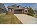 Attractive brick home with a two-car garage and long concrete driveway at 9413 Liberty Hill Dr, Mint Hill, NC 28227