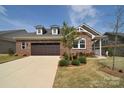 Beautiful brick home featuring a spacious driveway and well-kept lawn at 9413 Liberty Hill Dr, Mint Hill, NC 28227