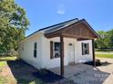 Charming home featuring white siding, a covered porch, and rustic wood accents at 1067 Old Charlotte Rd, Concord, NC 28027