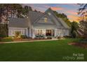 Charming home featuring a manicured lawn and inviting front porch at 115 Brawley Harbor Pl, Mooresville, NC 28117