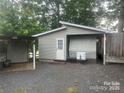 Exterior view of house with gravel parking and a small storage shed at 128 Twin Bluff Trl # C52, Mount Gilead, NC 27306