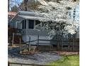 Charming home featuring a well-maintained exterior, complemented by a beautifully landscaped yard and blossoming tree at 128 Twin Bluff Trl # C52, Mount Gilead, NC 27306